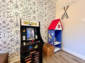 A Pac-Man arcade machine in a room with nautical wallpaper and a small house decoration. - *NEW*Peaceful Retreat-Firepit-WI Dells-Castle Rock (Mauston)