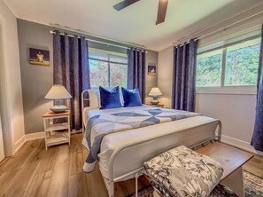 A bedroom with a bed, bedside tables, a bench, and curtains. - *NEW*Peaceful Retreat-Firepit-WI Dells-Castle Rock (Mauston)