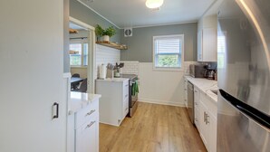 A kitchen with white cabinets, a stainless steel refrigerator, a wooden countertop, and a potted plant on the wall. - Walk to Dtwn Sandpoint! Family Gem w/ Patio & Yard (Sandpoint)