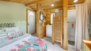 A wooden interior with a bed, a bathroom, and a shower area. - Brand New Casita by Superstition Mtns: Patio (Apache Junction)