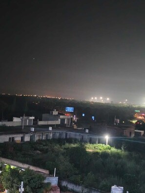 A nighttime view of a cityscape with buildings and streetlights.