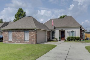 A two-story house with a brick exterior and a garage.