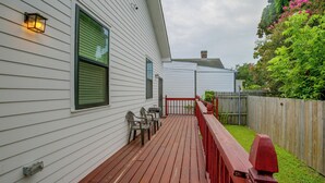 A wooden deck with outdoor furniture, a red railing, and a white building with windows. - Stylish Unit 3 Mi to French Quarter & Audubon Park (New Orleans)
