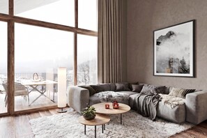 A modern living room with a large window, a grey sofa, a round coffee table, and a framed picture on the wall. - Modern studio near ski resort (Ladis)