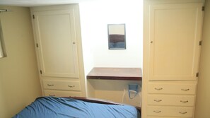 A bedroom with a bed, a desk, and a wardrobe. - Casa Vista del Mar  Relax, Unwind & Watch the Sunset (Playas de Rosarito)