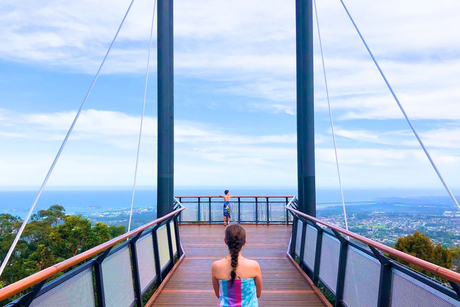 A pedestrian bridge with a view of a distant landscape.