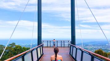 A pedestrian bridge with a view of a distant landscape.