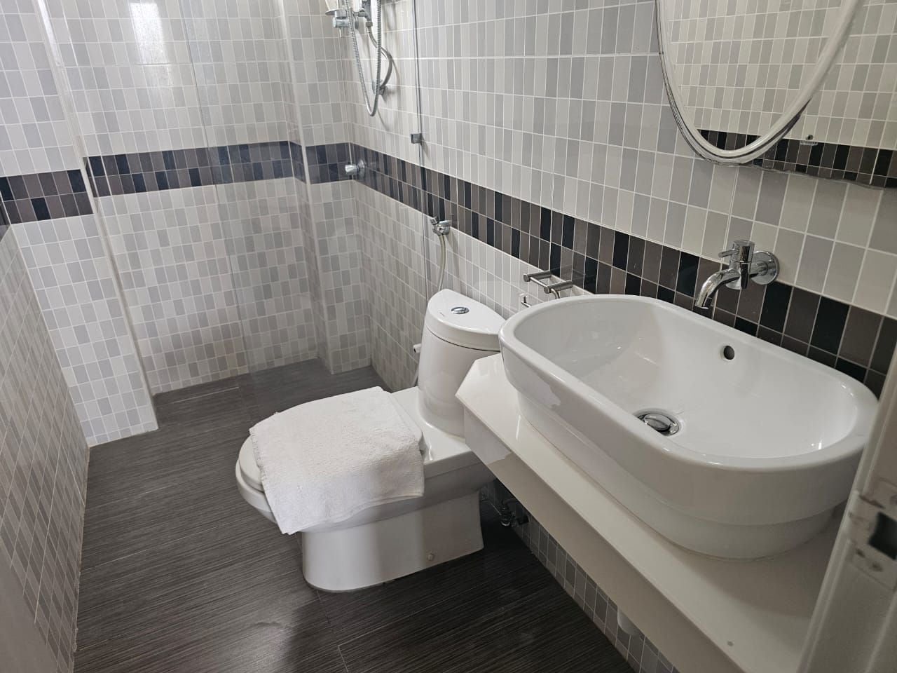 A bathroom with a toilet, a sink, and a shower.
