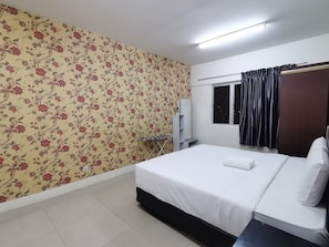 A hotel room with a bed, a wardrobe, a small desk, a mirror, and a window with curtains. - Putra Majestik Manage By City Haven (Jalan Ipoh)