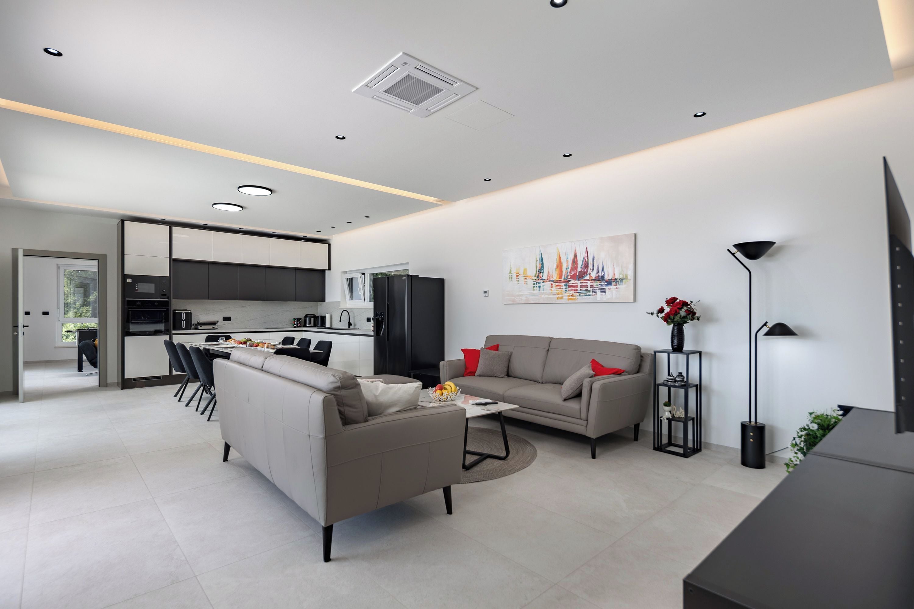 A modern living room with a sofa, a coffee table, and a TV stand.
