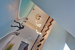 A modern interior with a unique ceiling design, including a hanging light fixture and abstract wall art. - Angels -  Luxurious 4-bedroom villa Pattaya sleeps 8 people (Muang Pattaya)