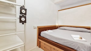A bedroom with a wooden bed, a grey mattress, and a white wall. - [FinestraNelBorgo] 5Terre-Portovenere-Seaview (Porto Venere)