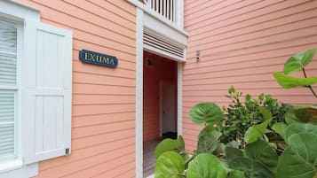 A building with a sign reading 'EXUMA' and a white door.