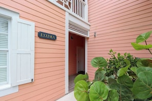 A building with a sign reading 'EXUMA' and a white door.