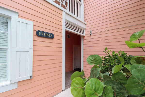 A building with a sign reading 'EXUMA' and a white door.