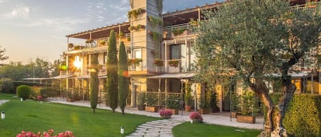 A multi-story building with a garden pathway leading to the entrance.