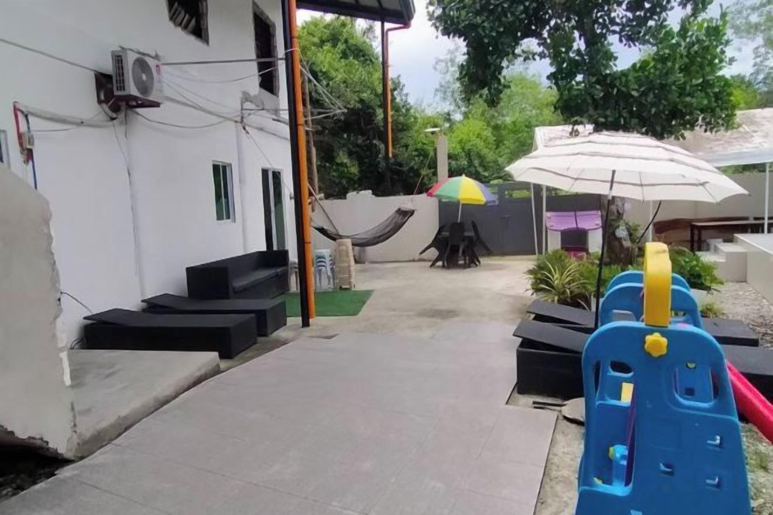 A patio area with outdoor seating, a hammock, and a play structure.