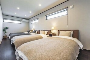 A hotel room with three beds, a potted plant, and a window. - PEACE OF REST TAKASHIMA (Takashima)