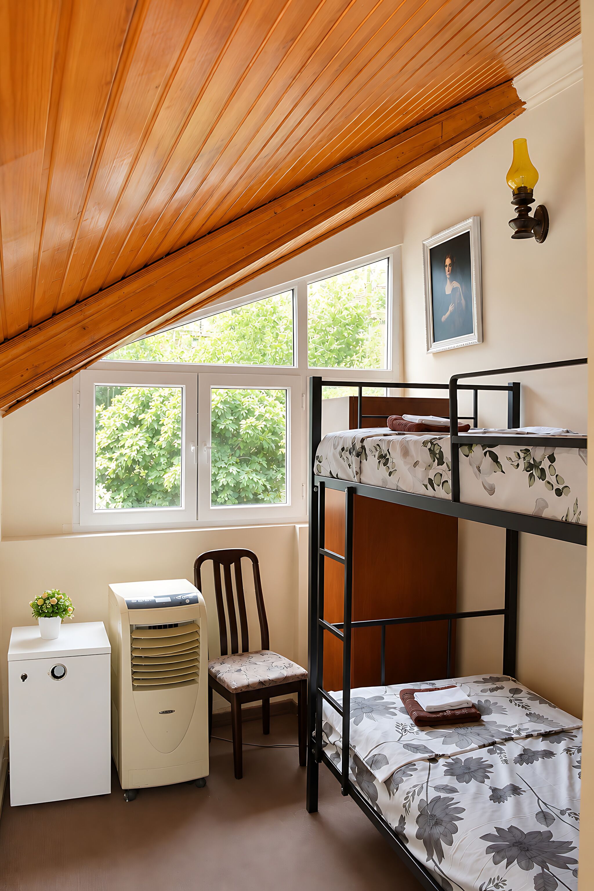 A bunk bed room with a desk, chair, and a radiator.