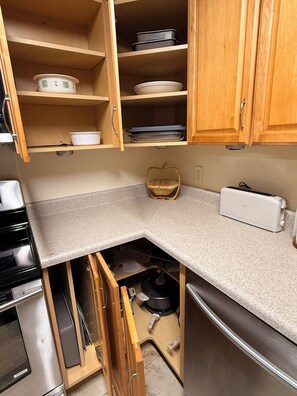 A kitchen with wooden cabinets, a countertop, a toaster, and a sink. - Guest house, convenient setting, large wooded lot of towering oaks (Hollister)