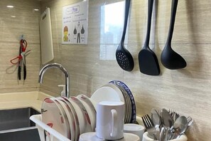 A kitchen area with a dish rack, utensils, and a faucet. - R&F Princess Cove Boutique Homestay By TREX #Nearby CIQ #Johor Bahru #JB Central (Johor Bahru)