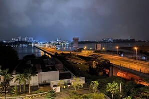 A nighttime cityscape with a river, a bridge, and a highway. - R&F Princess Cove Boutique Homestay By TREX #Nearby CIQ #Johor Bahru #JB Central (Johor Bahru)