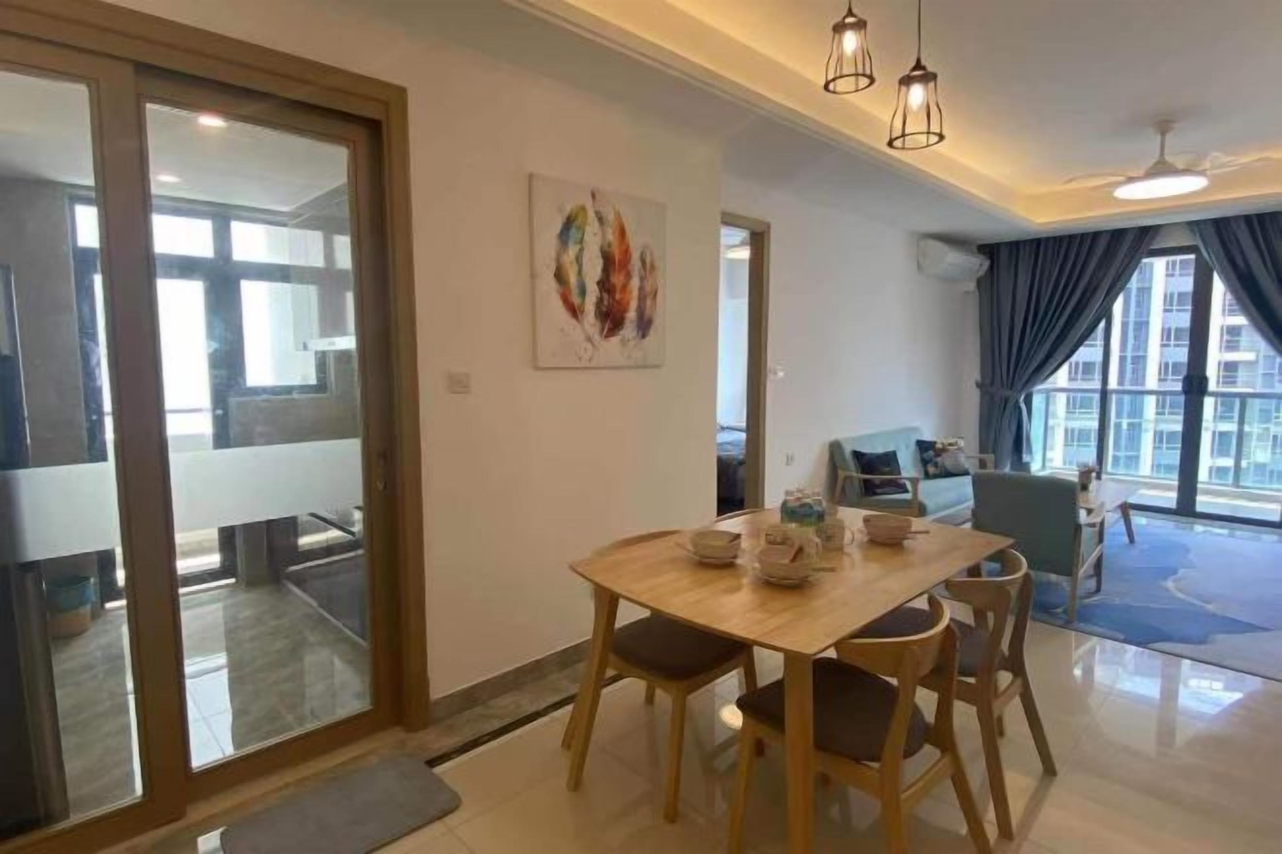 A dining area with a wooden table and chairs, a glass partition, and a view of the outside.