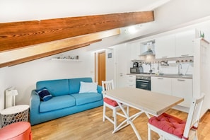 A compact kitchen with white cabinets, a microwave, and a stove. - [GoodTimes] Near the station-5Terre-A/C (La Spezia)