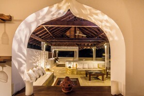 An indoor seating area with a wooden ceiling and a white archway. - Cinnamon House, Weligama by The Serendipity Collection (Weligama)