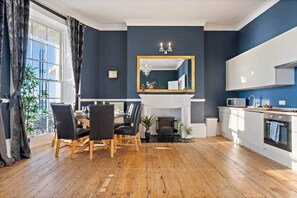 A modern kitchen with white cabinets, a microwave, and a sink. - 68 Marine Parade - BN2 1AD (Brighton and Hove)