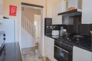 A kitchen with a stove, oven, and a toaster on the counter. - Fenham, Newcastle NE4 (Newcastle upon Tyne)