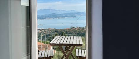 Ein Balkon mit Blick auf ein Gewässer und Berge.