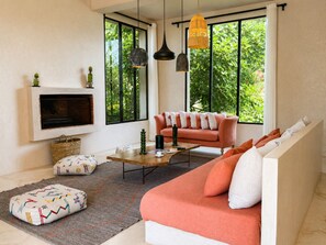 A modern living room with a sofa, coffee table, and a fireplace.