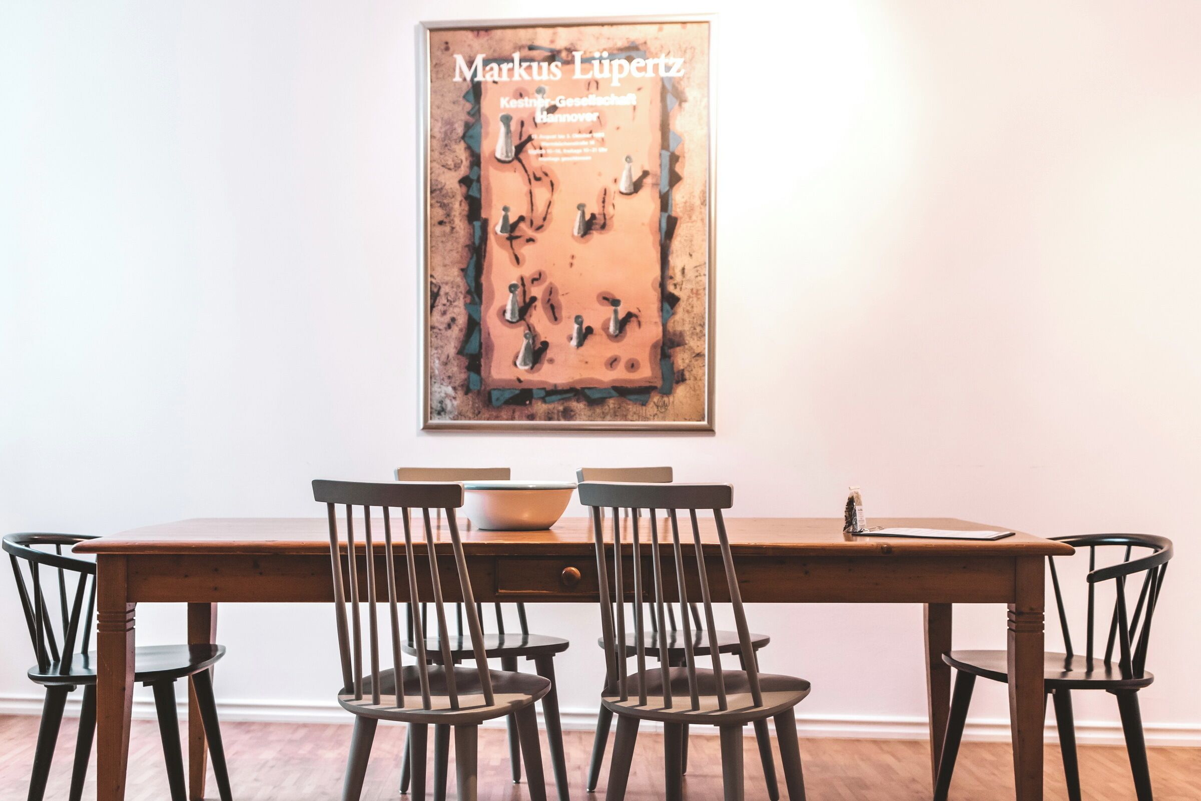 A dining area with a wooden table and four chairs.