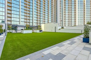 A modern residential building with a rooftop garden and a covered outdoor area. - 2BR Apartment With iconic view+Ample of amenities (Dubai)