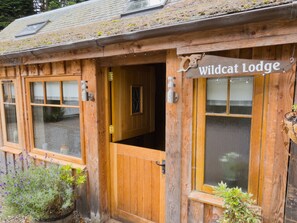 A wooden building with a sign reading 'Wildcat Lodge'. - Wildcat Lodge - couples retreat for two with a hot tub (Boat of Garten)
