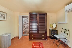 A room with a wardrobe, a bed with a metal frame, a dresser, a mirror, and a red patterned rug. - [IlGelsomino] Biassa-5Terre+A/C+ bus for 5 terre (Biassa)