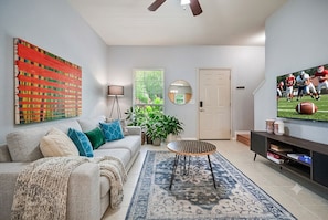 A living room with a sofa, coffee table, and TV.