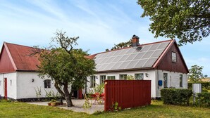A house with a red roof, white walls, and solar panels on the roof. - Awesome home in Tomelilla with WiFi (Tomelilla)