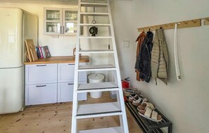 A kitchen with a white refrigerator, a wooden countertop, and a white ladder. There is a shelf with glassware and a clock. - Awesome home in Tomelilla with WiFi (Tomelilla)