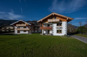 A two-story chalet with wooden balconies and a mountain backdrop. - Schönfeldspitze Vacation Rental, 145 square meters with 4 bedrooms (Schönau am Königssee)