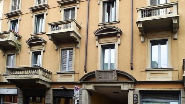 A multi-story building with balconies and a ground-level entrance. - Sant Agostino Rooms (Milan)