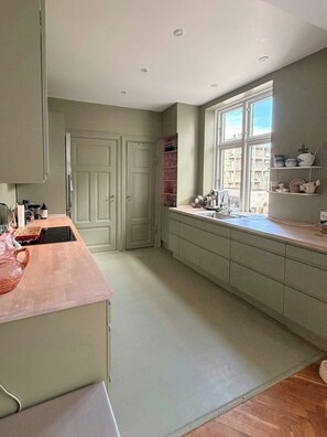 A kitchen with a window, cabinets, and a countertop. - Historic flat from the 1850s in Frederiksberg (Frederiksberg)