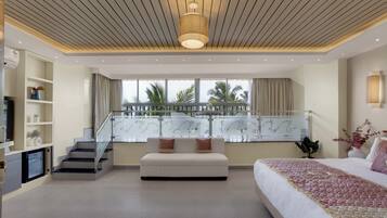 A modern bedroom with a large bed, a sofa, a TV, and a balcony with a railing.