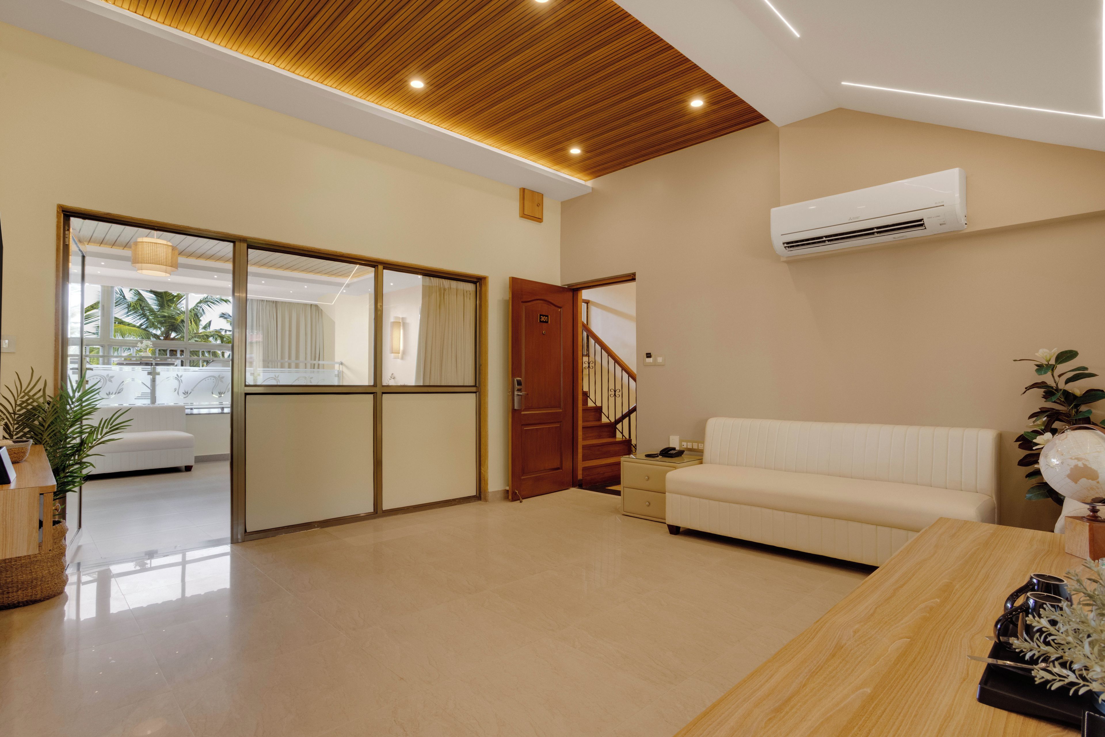A modern living room with a sofa, a wooden coffee table, and a globe.