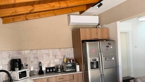 A compact kitchen with a built-in microwave, toaster, and refrigerator.