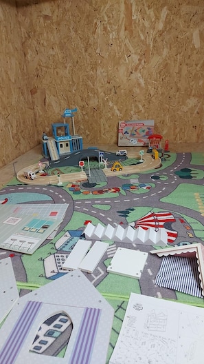 A playset with a police station, a puzzle box, and a road layout.