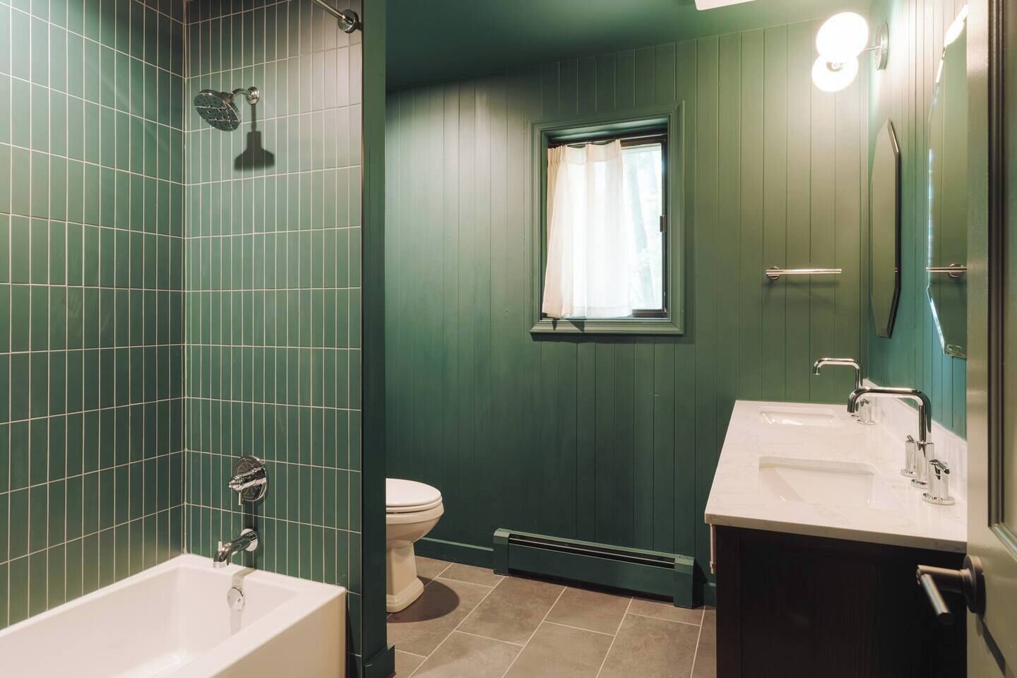 A bathroom with a bathtub, a toilet, and a sink.
