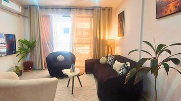 Deluxe Apartment | Living area | 32-inch Smart TV with digital channels
