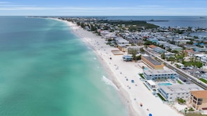 An aerial view of a coastal town with a beach, buildings, and a pier. - Brand New, Heated Pool/Spa, Minutes to Beach (Bradenton Beach)